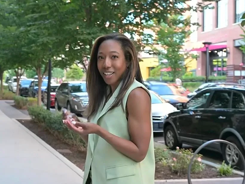 Sheri Otto on a city sidewalk, mid-conversation with a client during a content shoot