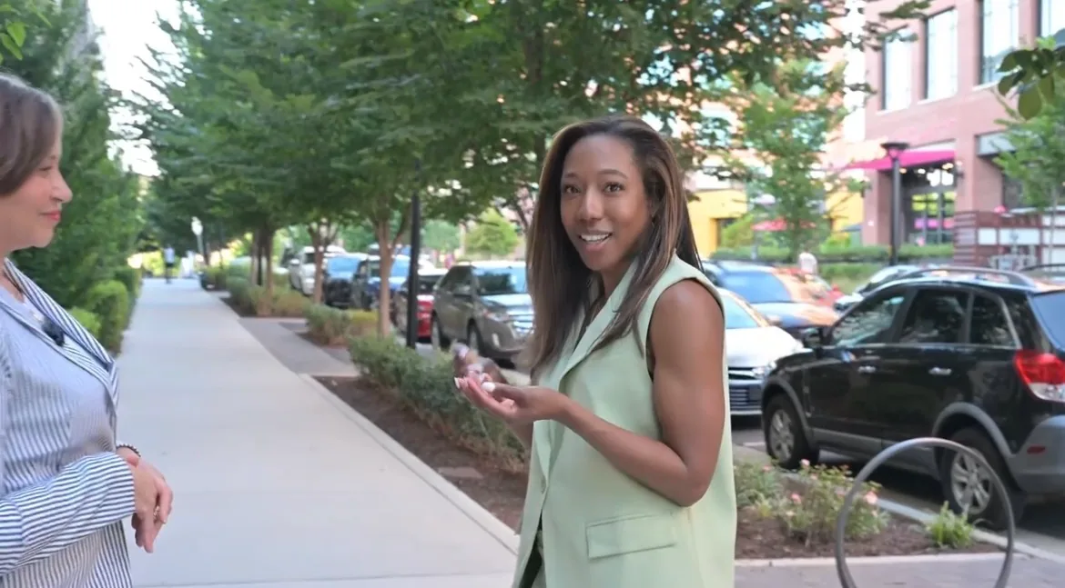 Sheri Otto talking with a friend on a tree-lined street